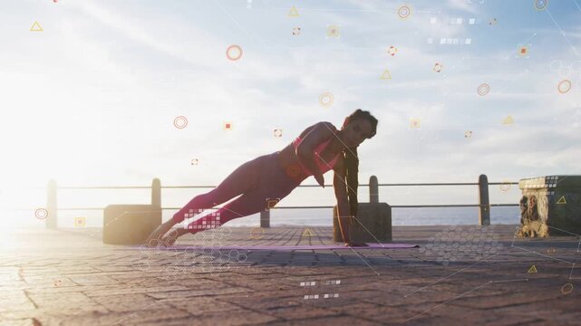 Woman doing fitness routine by ocean, shifting onto right hand, HUD highlighting form for balance