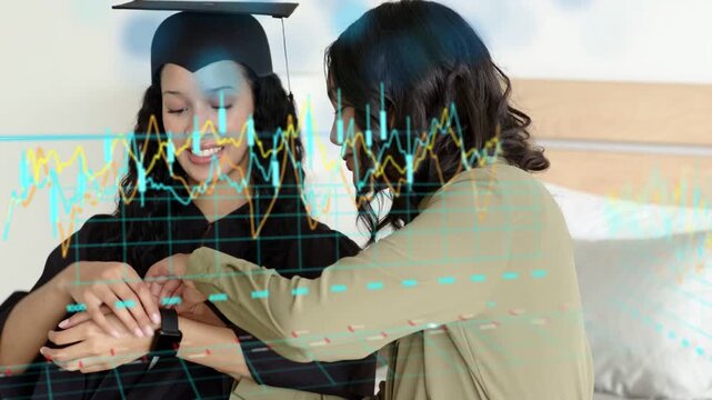 Grad in cap receiving gift as helper fastening wrist device while celebrating amid animated graphs