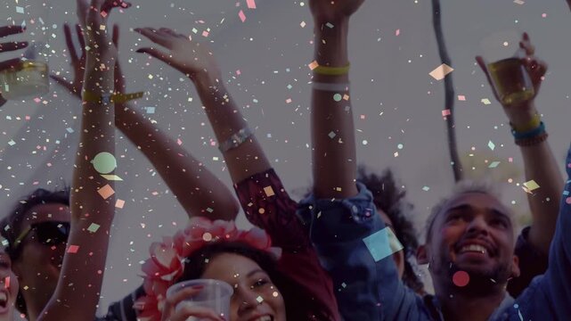 Front women raising cups and arms at music festival after confetti release, marking celebration