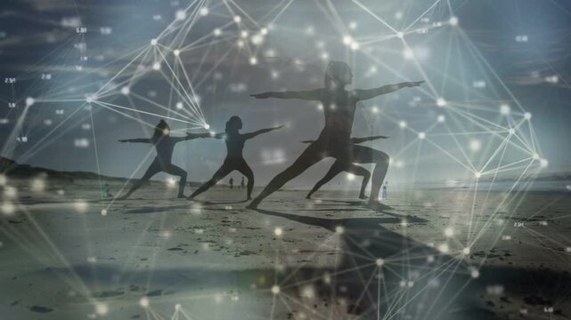 Three women holding warrior II on wet sand, digital nodes fading in and connecting for fitness