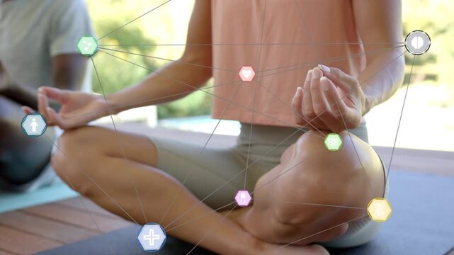 Woman meditating on deck, camera panning right, hex icons drawing near hand-knee, showing health