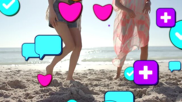 Friends nudging soccer ball on sunny beach, playing as social media icons rising and obscuring feet