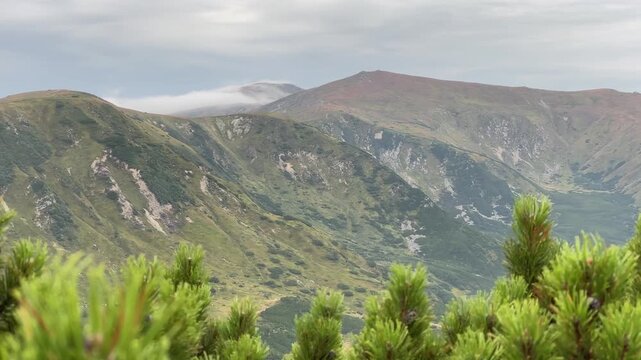 Scenic Mountain Landscape. Serene Alpine Valley With Misty Ridge And Rolling Hills