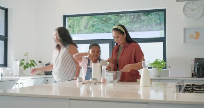 Female family making batter on island youth reaching canister, mom guiding glass bowl, gran sifting