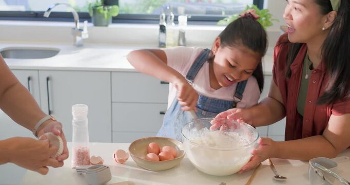 Diverse family baking muffins at kitchen counter, child whisking in glass bowl, adults lining tin