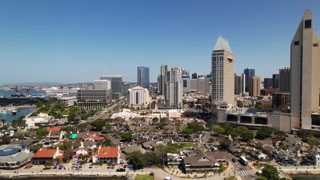 Drone flying toward the west side near Seaport Village in downtown San Diego at 12 noon capturing waterfront and city views.