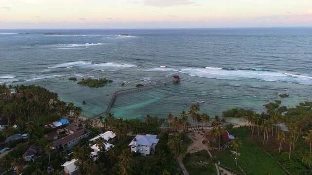 General Luna coastline at sunset, Siargao Island Cloud 9 boardwalk famous surfing spot in Philippines , aerial drone footage