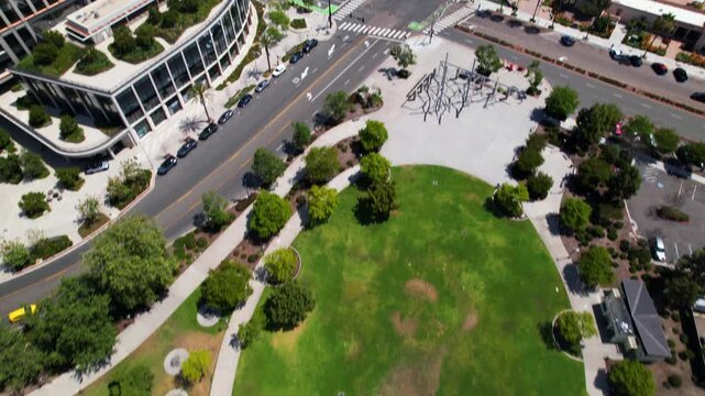 Drone flying forward at 12 noon with camera facing down and slowly tilting up to reveal the downtown San Diego skyline.