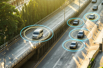 Satellite car navigation. Cars are driving along road. Large road junction. Lines connect moving cars. Concept satellite navigation tech. Tracking vehicles from satellite. Use navigation technologies © funfunphoto