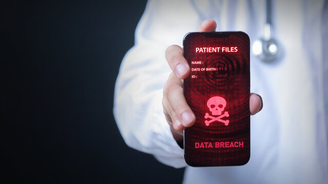 Concerned doctor holding smartphone displaying serious warning about medical patient data breach with skull symbol indicating hacker threat