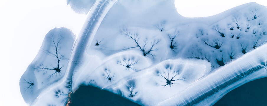 Landscape, tourism: Aerial view of frozen lake with ice patterns resembling trees, winter environment, Fusine lakes, Tarvisio, Friuli, Italy.