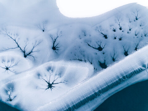 Landscape, tourism: Aerial view of frozen lake with ice patterns resembling trees, winter environment, Fusine lakes, Tarvisio, Friuli, Italy.