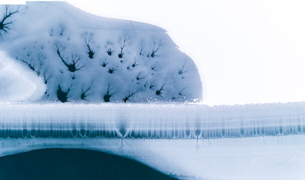 Landscape, tourism: Aerial view of frozen lake with ice patterns resembling trees, winter environment, Fusine lakes, Tarvisio, Friuli, Italy.