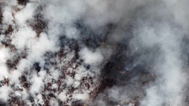 Aerial drone view of fire burning at landfill site