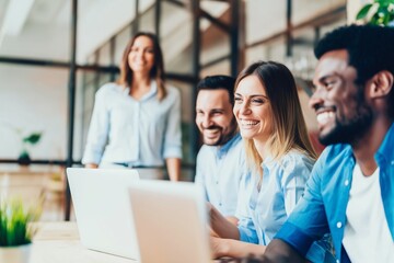 Obraz premium Business team smiling working together on laptops representing collaboration communication and modern office productivity