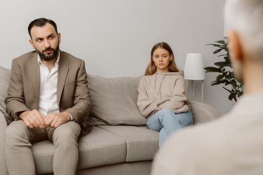 Family therapy session with parents and child discussing emotions and communication in supportive environment indoors