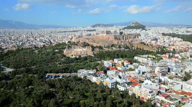 Aerial drone view of Acropolis of Athens with Parthenon and Odeon of Herodes Atticus. Scenic panorama of historic city center and modern Athens skyline, Greece.