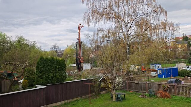 Drilling rig installing pylons for residential building construction heavy machinery in action