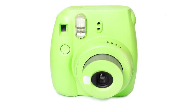 Retro instant camera in a vibrant lime green color on a clean white background