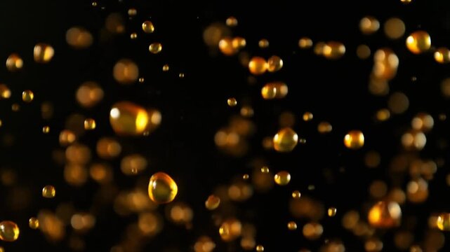 Golden Oil Droplets Jumping and Splashing on Black Background