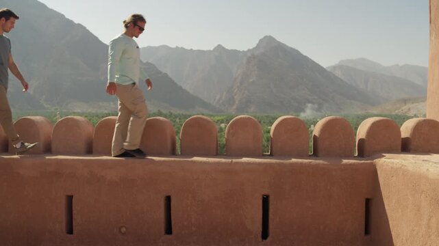 Slow Motion Tourist Exploring Nakhal Fort, Cinematic Male Traveler at Historic Omani Fortress