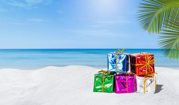 Colourful gift box on tropical sandy beach, holiday gift, summer promotion, outdoor day light