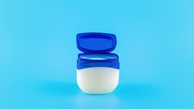 Three identical petroleum jelly jars lined up on a vibrant blue background