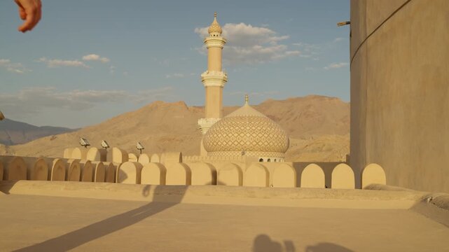 Slow Motion Man Walking on Nizwa Fort at Sunset, Cinematic Traveler on Historic Omani Battlements