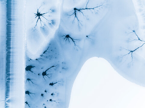 Abstract ice background shows frozen patterns, texture and copy space, Fusine lakes, Tarvisio, Friuli, Italy.