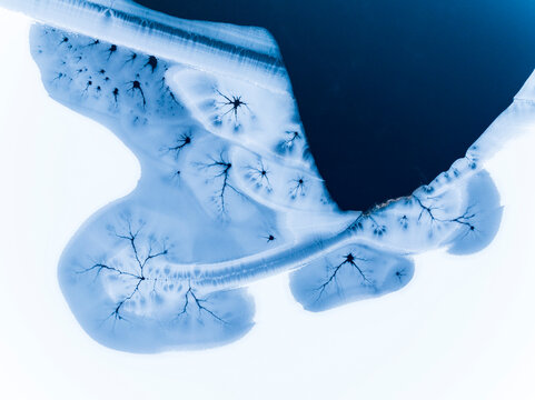 Landscape, tourism: Aerial view of frozen lake with ice patterns, creating a unique winter destination, Fusine lakes, Tarvisio, Friuli, Italy.
