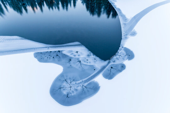 Winter landscape, aerial view of frozen lake and snow-covered mountains, tourism and destination concept, Fusine lakes, Tarvisio, Friuli, Italy.