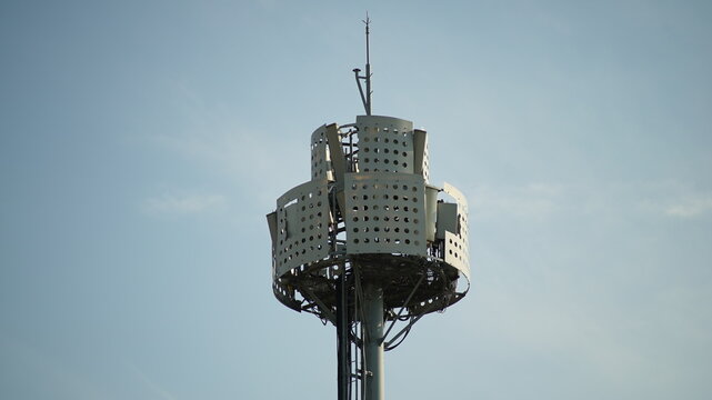 Close up of a cellular base station antenna tower for 5G telecommunication against a clear blue sky