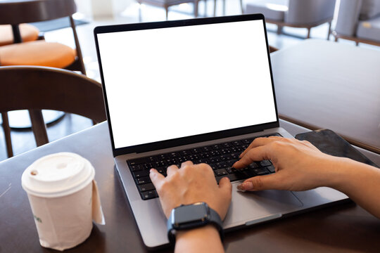 mock up businessman working empty screen computer on wood desk in cafe. Notebook Laptop with blank screen