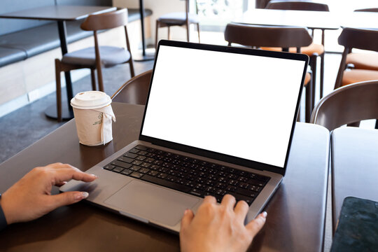mock up businessman working empty screen computer on wood desk in cafe. Notebook Laptop with blank screen