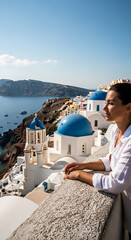 Obraz premium Profile view of woman against Santorini vista with white buildings, blue domes, and Aegean Sea, showcasing idyllic travel, vacation and cultural experience