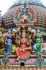Fototapeta premium Detail of the exterior of the Sri Mariamman Temple, Singapore's oldest Hindu temple, featuring colorful, plaster sculptures of Hindu deities and other ornamental figures and objects.