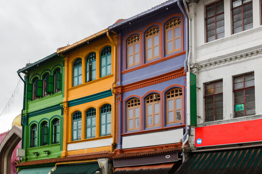 Exterior architectural detail of the facade of ornate, colorful, traditional, old, colonial-era buildings in the Arab neighborhood of  Kampong Glam, a historic district near Bugis, Singagpore.
