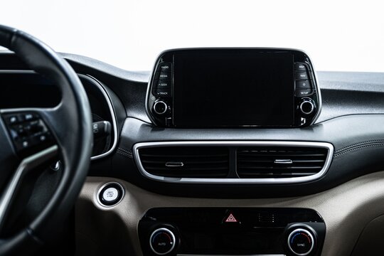 Close up of a modern car dashboard with infotainment display screen. The screen can be used for navigation media and digital advertising content inside the vehicle
