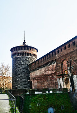 Sforza Castle (Castello Sforzesco) specifically showcasing the Torrione del Carmine (East tower) and a section of its fortified brick walls, Milan, Italy, Europe 