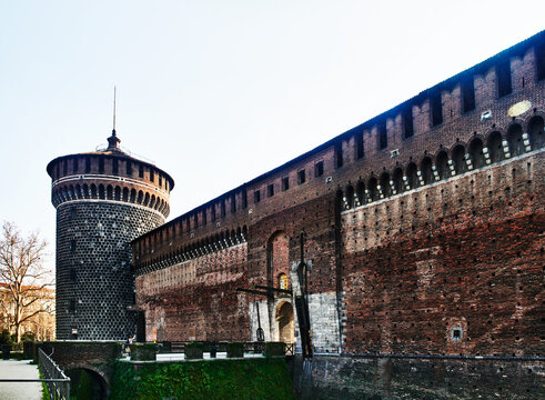 Sforza Castle (Castello Sforzesco) specifically showcasing the Torrione del Carmine (East tower) and a section of its fortified brick walls, Milan, Italy, Europe 