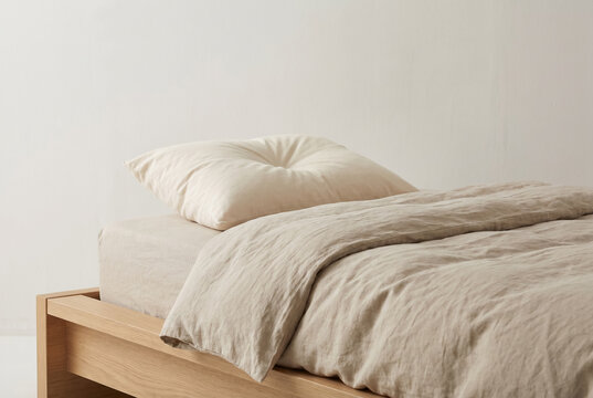 Minimal Bed with Beige Bedding Soft Natural Light Calm Interior