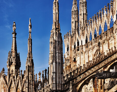 The rooftop of the Milan Cathedral (Duomo di Milano), a masterpiece of Gothic architecture featuring intricate details and a dense forest of spires, Milan, Italy, Europe 