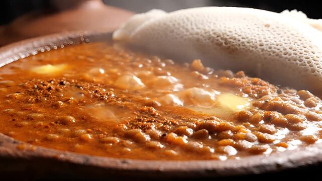 Delicious Ethiopian Lentil Stew Served with Injera Bread Closeup.