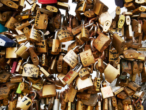 Collection of love locks on a bridge over the Naviglio Grande, one of the historic canals in the Navigli district of Milan, Italy, Europe