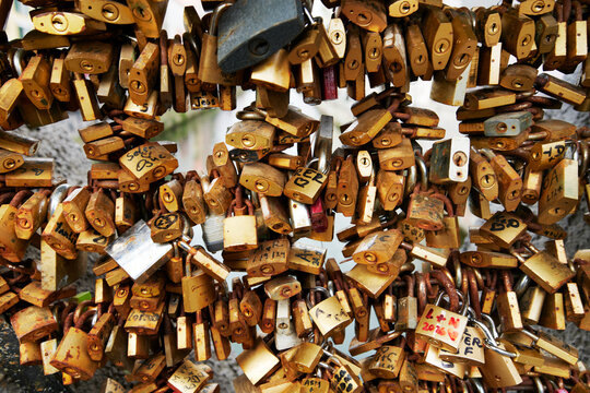 Collection of love locks on a bridge over the Naviglio Grande, one of the historic canals in the Navigli district of Milan, Italy, Europe
