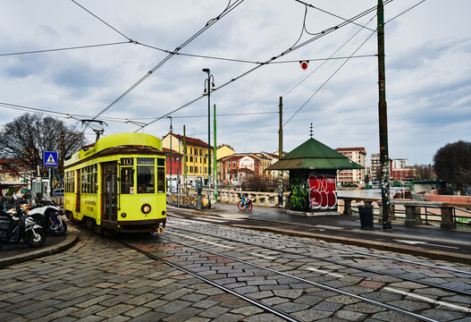 A classic yellow ATM Class 1500 tram, a iconic form of public transport that has operated in Milan, Italy since the 1920s, Navigli district, Milan, Italy, Europe 
