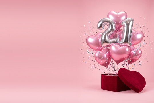21st Birthday Celebration Pink Heart Balloons and Silver Number Balloons Bursting from Gift Box