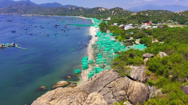 Aerial Drone Flyover Beach Near Vinh Hy with Square Aquaculture Net Frames on Sand and Turquoise Sea Ninh Thuan Vietnam