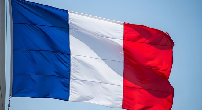 Celebrating bastille day vibrant french flag against a clear blue sky