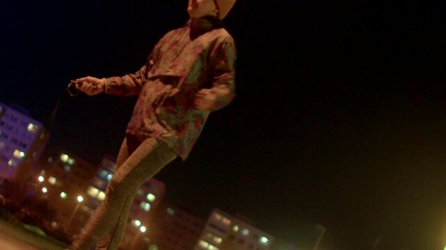 Artistic urban motion. Street performance captured with vibrant city lighting and movement. Intimate shot portraying energetic urban dance against glowing city backdrop